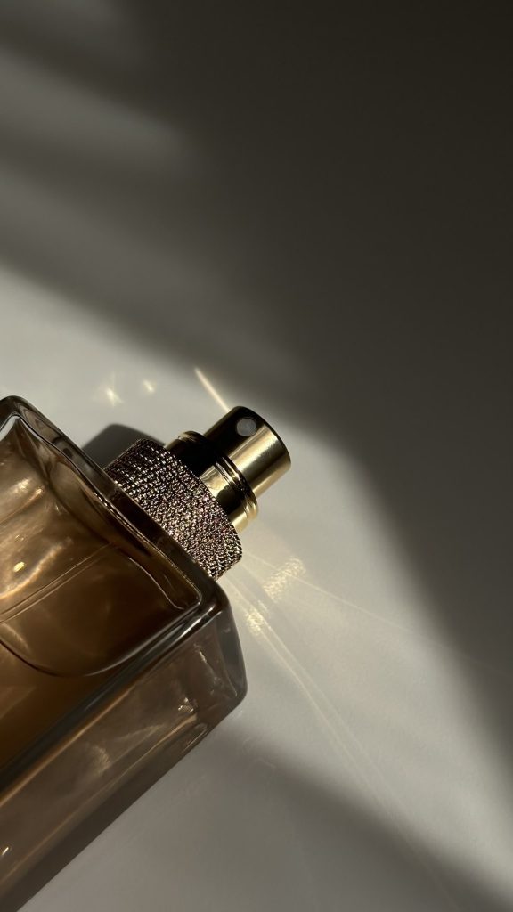 An up-close image of a perfume bottle top.